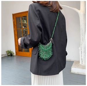 Detailed close-up of handmade green beaded fringe crossbody bag with emerald resin beads