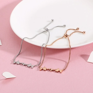 Adjustable stainless steel fish and heartbeat bracelet in silver and rose gold finishes