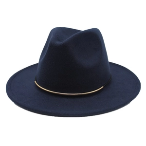Close-up of dark blue wool fedora hat with gold metal buckle band and flat brim