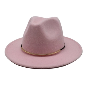 Detailed view of pink wool fedora hat featuring a black and gold buckle band decoration