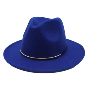 Detail of royal blue fedora hat featuring a chic gold metal buckle and black band trim