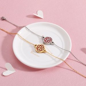 Set of gold and silver stainless steel bangles with hollow rose disc on white plate