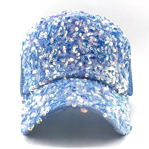 Close-up of light blue baseball cap featuring shimmering sequins and breathable mesh panels