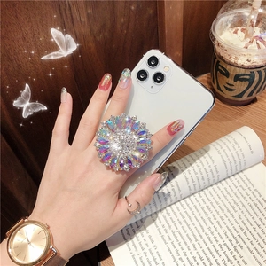 Sparkling crystal sunflower phone socket holder with multicolored rhinestones on white phone