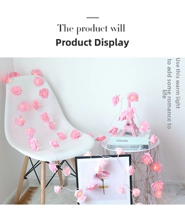 Detail of pink rose LED string lights on a white chair creating a warm romantic vibe