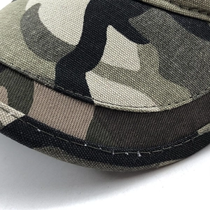 Macro detail of camouflage cotton fabric with precise double-row stitching on the brim