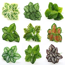 Detail showing nine varieties of artificial foliage including monstera and calathea leaves