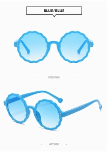 Close-up of blue scalloped round frame sunglasses with gradient lenses and metal rivets