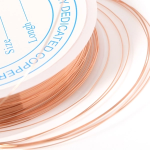 Macro shot of rose gold copper wire spool for DIY jewelry making and beading details