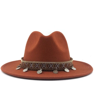 Rust orange wool jazz hat with ethnic woven band and antique silver coin pendants