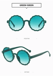 Detailed views of kids retro round sunglasses with scalloped edges in deep green