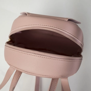 Pink leather mini backpack top view showing zipper closure and textured PU material