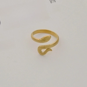 Close-up of golden snake ring with textured scale patterns and adjustable open band