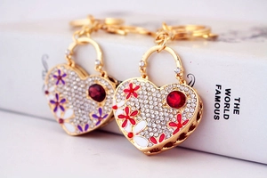 Macro shot of rhinestone heart keychains with flower motifs and red gemstones