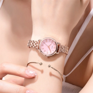 Elegant rose gold quartz watch with pink dial and matching metal bracelet on wrist