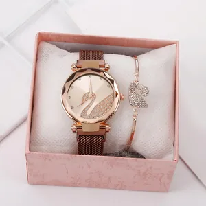 Detail of rose gold quartz watch and matching swan bracelet in a premium gift box