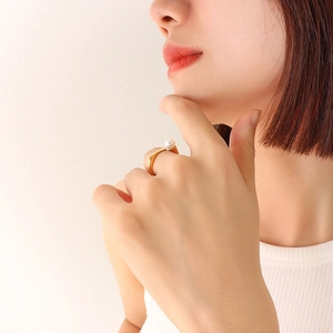 French vintage style gold-plated titanium ring with elegant white pearl on model's hand