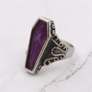 Detailed side view of vintage silver ring with purple coffin-shaped gemstone inlay