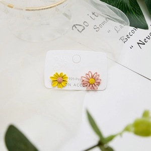 925 silver needle daisy earrings in yellow and pink on elegant lace background