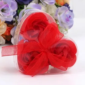 Romantic heart-shaped gift box with three red soap roses and elegant red ribbon bow