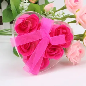 Close-up of heart-shaped gift box with six magenta soap roses and pink ribbon bow decoration