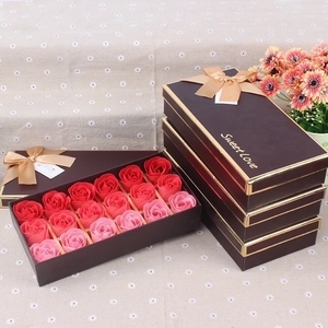 Close-up of 18 red and pink soap roses in a brown gift box with golden Sweet Love ribbon