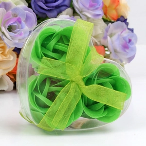 Close-up of green heart-shaped soap flower gift box with elegant ribbon bow