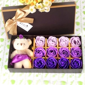 Gift box with purple soap rose flowers and a plush bear toy for romantic occasions