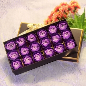 Detail of 18 purple rose soap flowers in a black gift box with a yellow ribbon bow