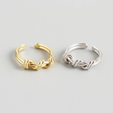 Detail of minimalist S925 sterling silver twisted rope rings in gold and silver finish