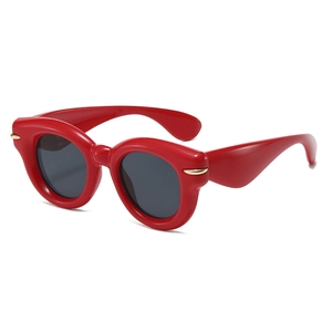 Fashionable oversized red cat-eye sunglasses with dark grey lenses and gold accents