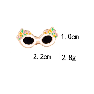 Detailed view of floral sunglasses enamel pin with dimensions 1.0cm by 2.2cm