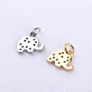Detailed view of two elephant pendant charms in gold and silver with cubic zirconia
