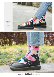 Detailed close-up of white and pink socks with colorful flower patterns on a model