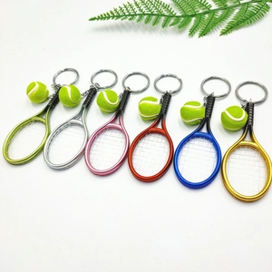 Set of mini tennis racket and ball keychains in six vibrant metallic and neon colors
