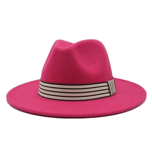 Detail of hot pink wool fedora hat featuring a stylish black and white striped band