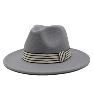 Detailed view of grey wool fedora hat with a decorative black and white striped ribbon band