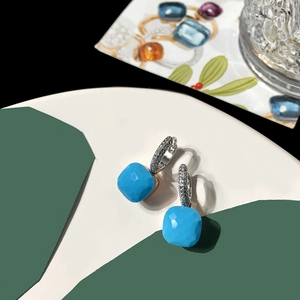 Macro detail of sky blue square cut crystal earrings with silver pavé-set crystals
