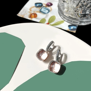 Macro shot of champagne square stone earrings with silver micro-paved diamond hoops