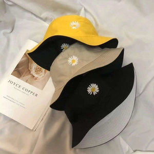 Kids reversible bucket hats with daisy embroidery in yellow, beige and black colors