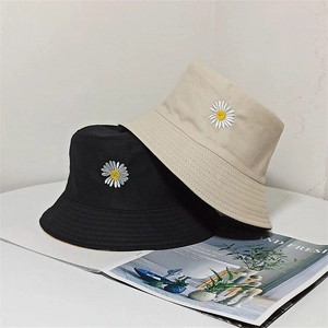 Detail of cotton canvas sun hat featuring daisy embroidery in black and beige colors