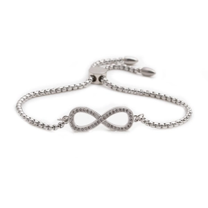 Adjustable infinity bracelet in silver metal featuring sparkling white cubic zirconia stones
