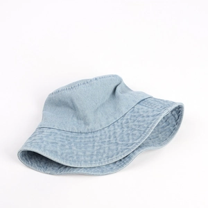 Close-up of light blue denim bucket hat featuring reinforced stitching on the wide brim