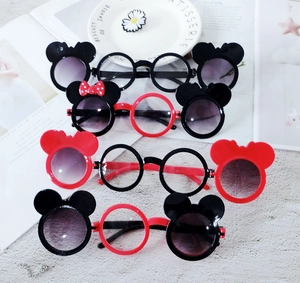 Close-up of funny daisy sunglasses with Mickey ears and polka dot bow for parties