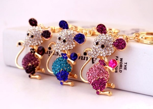 Detailed view of three mouse keychains with rhinestones in purple, blue and pink colors