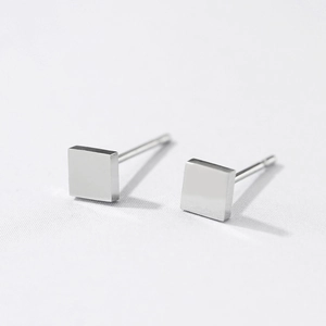 Macro shot of polished silver square stud earrings in 316L stainless steel design