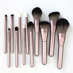 Detail view of 12-piece makeup brush set with pink handles and dark gradient bristles