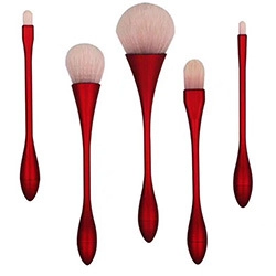 Detail view of 5 ergonomic red metallic makeup brushes with soft white bristles