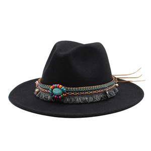 Detail of wool fedora hat with bohemian ethnic band, turquoise stone and grey tassels