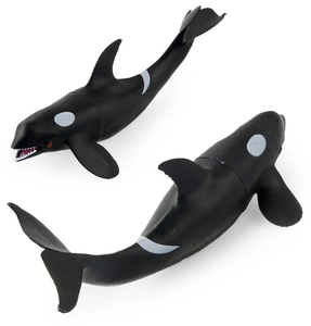 Detailed macro view of two realistic orca toy figures showing fine texture and white base